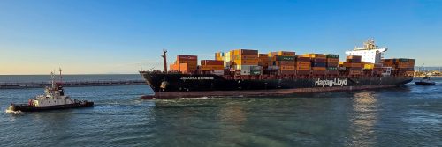 TUG ESCORTING CARGO SHIP FROM LIVORNO HARBOUR by Janice Kennaway
