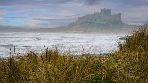 TOWERING ABOVE THE WAVES BAMBURGH CASTLE by Mike Cantrell